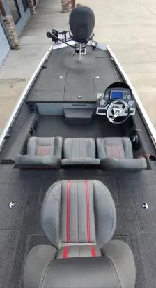 Slide: The Image of 2014 Ranger RT188 boat interior with gray and red seating, steering console, and fishing deck. - 12