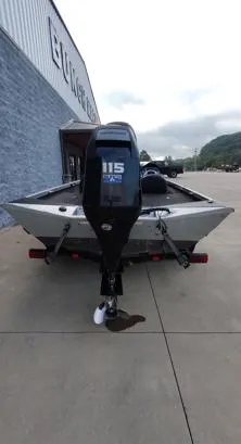 Slide: The Image of 2014 Ranger RT188 boat with 115 HP motor, parked outside a building. - 14