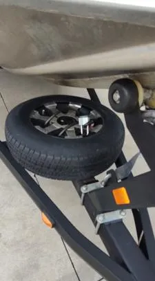 Slide: The Image of Trailer wheel of a 2014 Ranger RT188 boat on a concrete surface. - 3