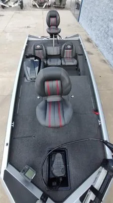 Slide: The Image of 2014 Ranger RT188 fishing boat with gray and red seats, spacious deck, and modern controls. - 8
