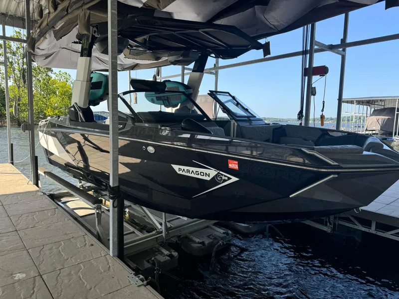 Slide: The Image of 2023 Nautique Super Air Nautique G25 Paragon boat docked on a lift. - 1