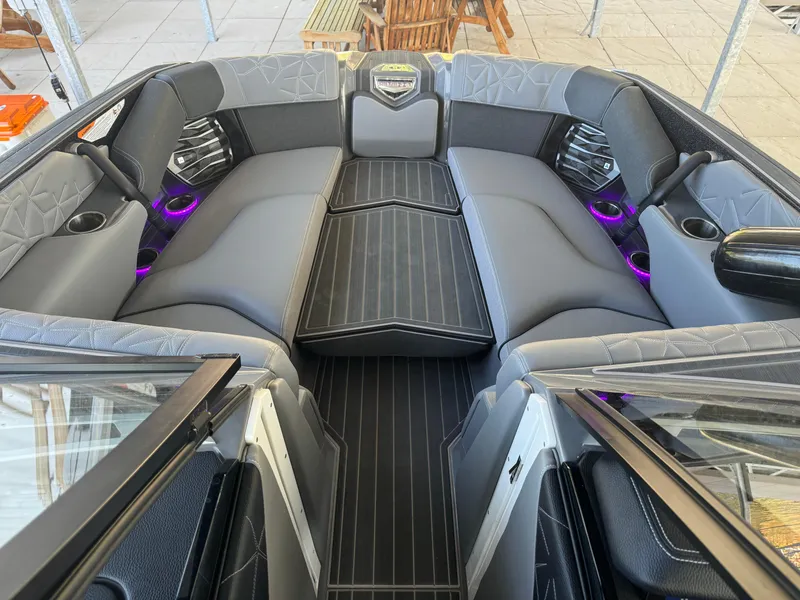 Slide: The Image of 2023 Nautique Super Air Nautique G25 Paragon interior with luxurious seating and ambient lighting. - 10