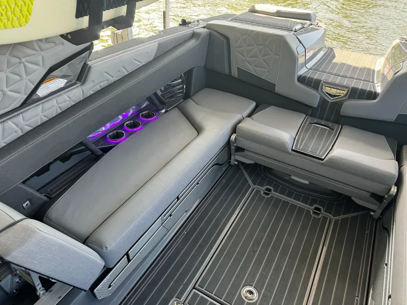 Slide: The Image of 2023 Nautique Super Air Nautique G25 Paragon interior with luxurious seating and cup holders. - 12