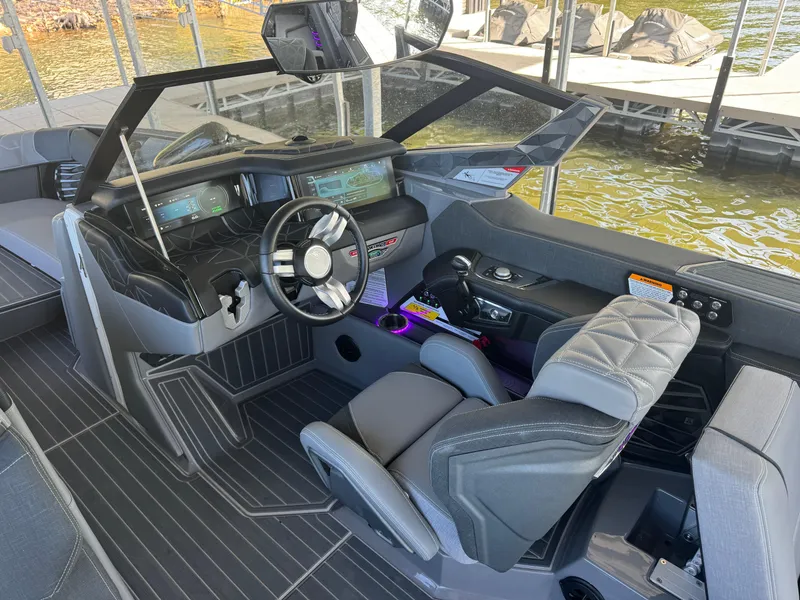 Slide: The Image of 2023 Nautique Super Air Nautique G25 Paragon cockpit with modern controls and luxurious seating. - 13