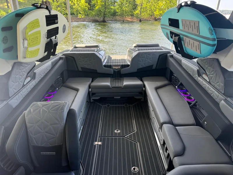 Slide: The Image of 2023 Nautique Super Air Nautique G25 Paragon interior with luxury seating and surfboards. - 14