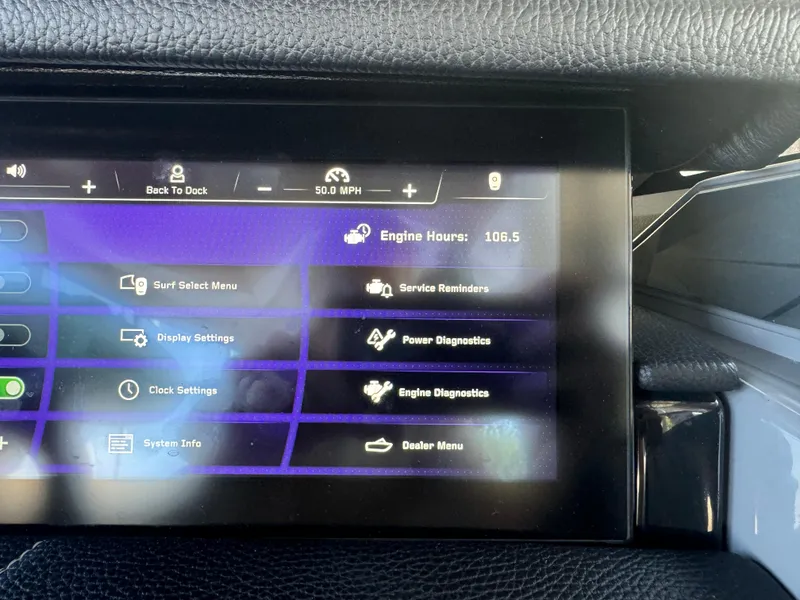 Slide: The Image of 2023 Nautique Super Air Nautique G25 Paragon dashboard display showing engine hours and settings menu. - 16
