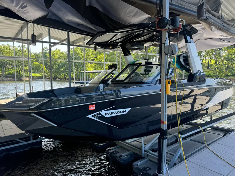 Slide: The Image of 2023 Nautique Super Air Nautique G25 Paragon boat docked in a marina. - 3