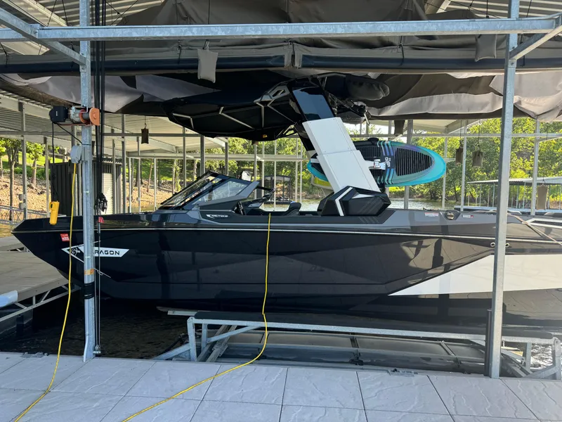 Slide: The Image of 2023 Nautique Super Air Nautique G25 Paragon docked in a covered boat lift. - 4