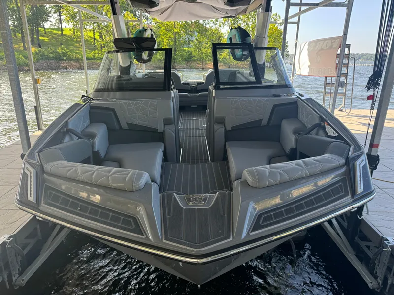 Slide: The Image of 2023 Nautique Super Air Nautique G25 Paragon boat interior, docked by a scenic lake. - 5