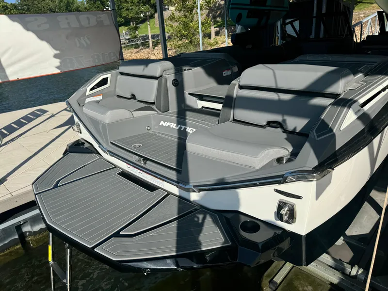 Slide: The Image of 2023 Nautique Super Air Nautique G25 Paragon boat with sleek gray seating and swim platform. - 6