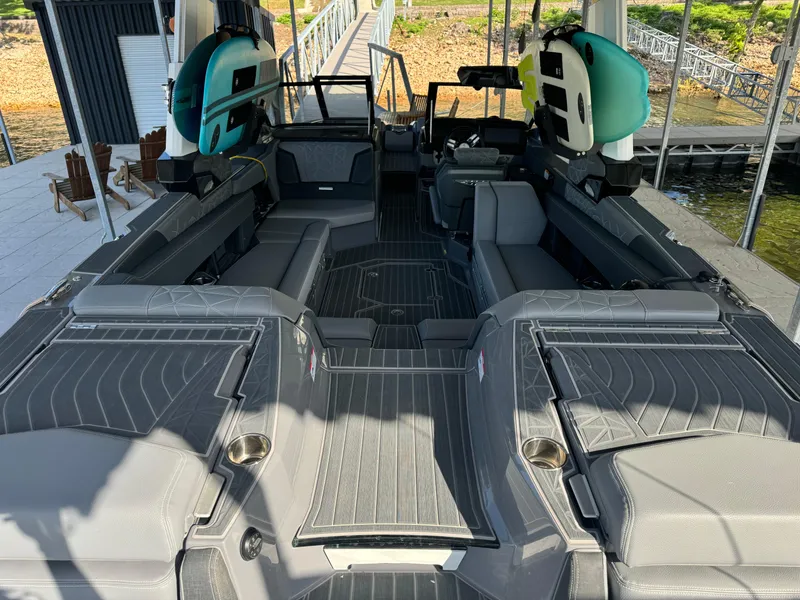 Slide: The Image of 2023 Nautique Super Air Nautique G25 Paragon interior with sleek seating and surfboards. - 7