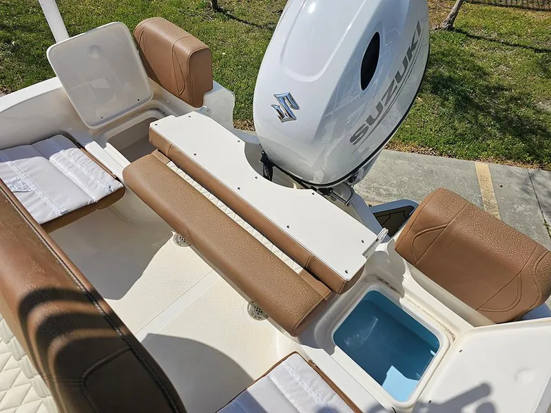 Slide: The Image of 2025 Pioneer 180 Islander boat interior with Suzuki engine, featuring brown seating and storage compartments. - 10