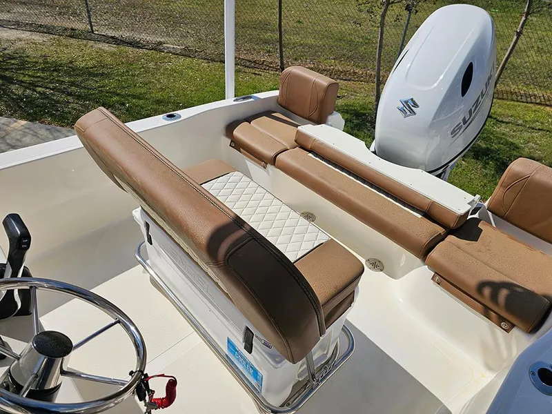 Slide: The Image of 2025 Pioneer 180 Islander boat interior with brown seating and Suzuki outboard motor. - 12