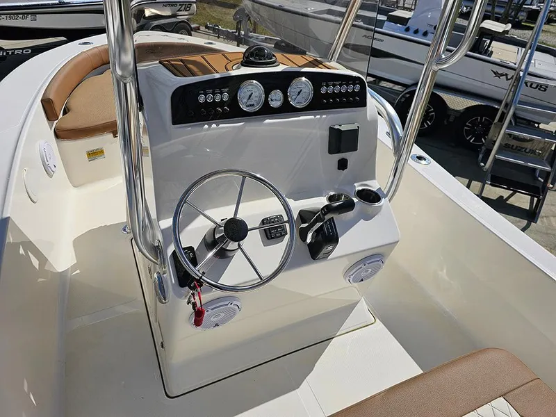 Slide: The Image of 2025 Pioneer 180 Islander boat console with steering wheel and gauges. - 13