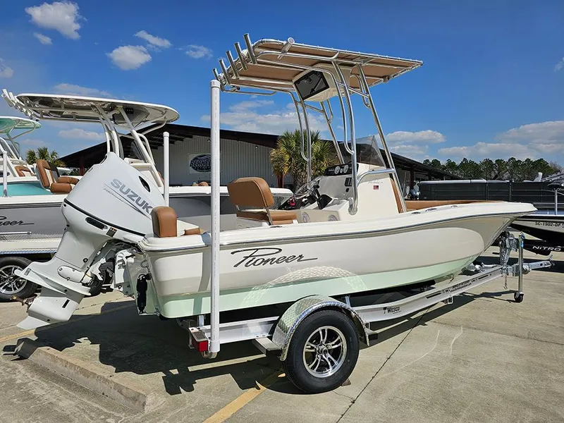 Slide: The Image of 2025 Pioneer 180 Islander boat with Suzuki engine on trailer, parked outdoors. - 3