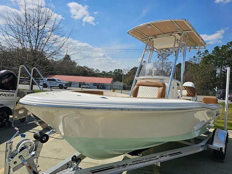 Slide: The Image of 2025 Pioneer 180 Islander boat on trailer under clear blue sky. - 5