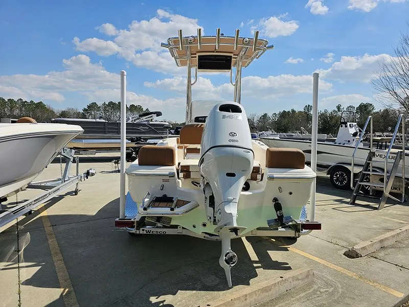 Slide: The Image of 2025 Pioneer 180 Islander boat with Yamaha engine, parked outdoors under a clear blue sky. - 8