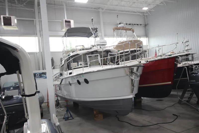 Slide: The Image of 2024 Ranger Tugs R-29 Command Bridge LE in indoor storage facility. - 11