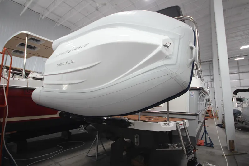 Slide: The Image of 2024 Ranger Tugs R-29 Command Bridge LE in a showroom, rear view. - 16