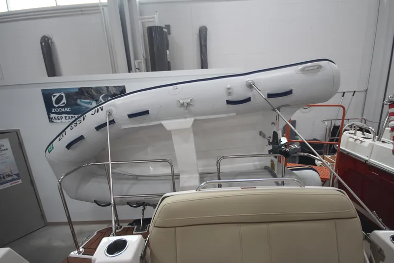 Slide: The Image of 2024 Ranger Tugs R-29 Command Bridge LE with mounted inflatable boat in showroom. - 19