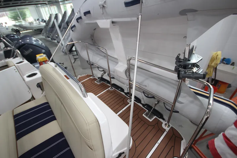 Slide: The Image of 2024 Ranger Tugs R-29 Command Bridge LE interior with seating and deck details. - 20