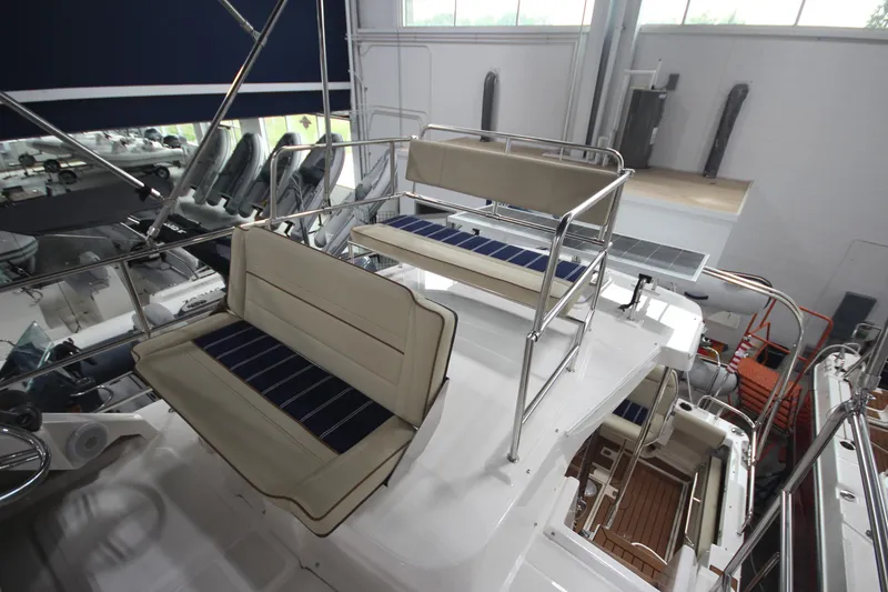 Slide: The Image of 2024 Ranger Tugs R-29 Command Bridge LE interior with cushioned seating and modern design. - 22