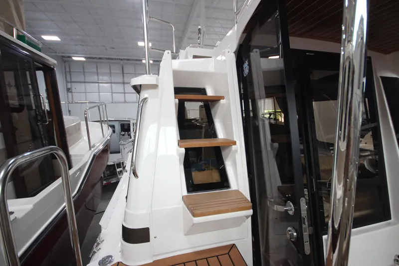 Slide: The Image of 2024 Ranger Tugs R-29 Command Bridge LE, interior stairs and door detail. - 26