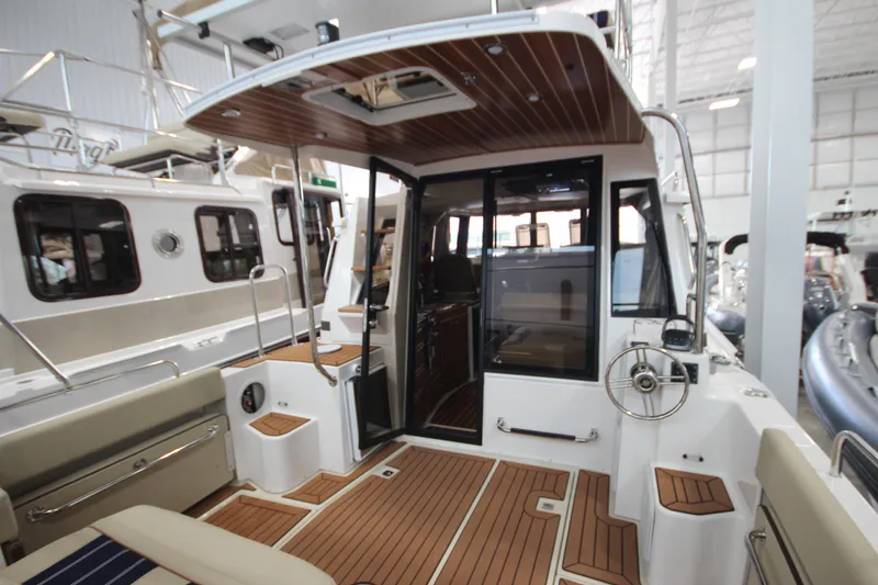 Slide: The Image of 2024 Ranger Tugs R-29 Command Bridge LE, showcasing elegant deck and interior design. - 27