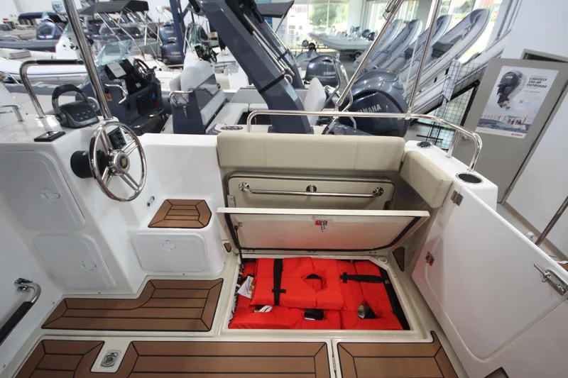 Slide: The Image of 2024 Ranger Tugs R-29 Command Bridge LE interior with storage and safety equipment. - 34