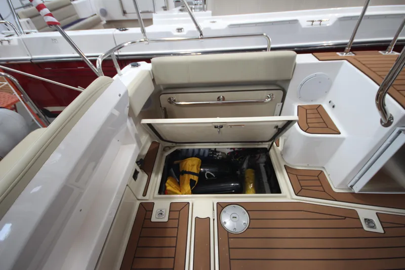 Slide: The Image of 2024 Ranger Tugs R-29 Command Bridge LE, open storage compartment on teak deck. - 35