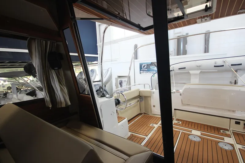 Slide: The Image of 2024 Ranger Tugs R-29 Command Bridge LE interior with teak flooring and helm station. - 40