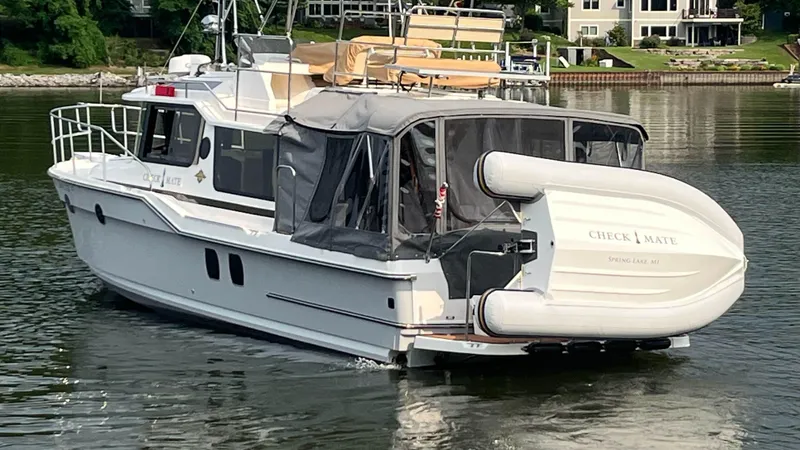 Slide: The Image of 2024 Ranger Tugs R-29 Command Bridge LE boat on calm water, rear view. - 7
