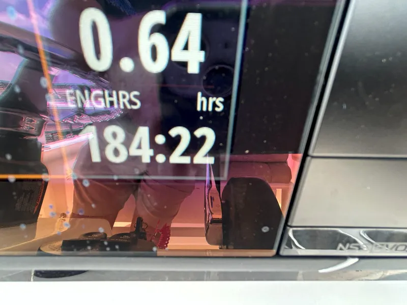 Slide: The Image of Display screen showing engine hours on a 2016 Sportsman Open 232 Center Console boat. - 17