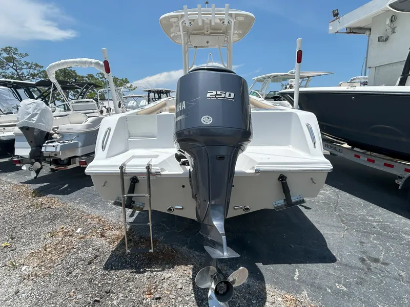 Slide: The Image of 2016 Sportsman Open 232 Center Console boat with Yamaha 250 engine, parked outdoors. - 5