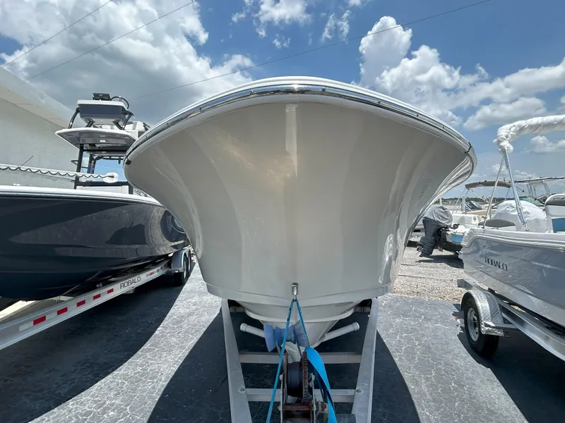 Slide: The Image of 2016 Sportsman Open 232 Center Console boat on trailer under blue sky. - 6