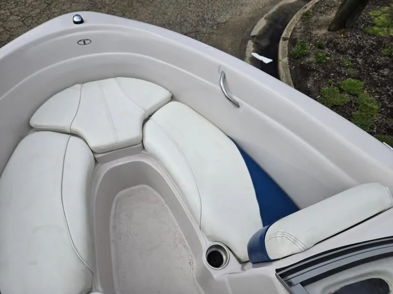 Slide: The Image of 2006 Tahoe Q6 boat interior with white cushioned seating and cup holder. - 10