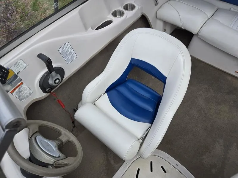 Slide: The Image of 2006 Tahoe Q6 boat interior with white and blue seating, steering wheel, and control panel. - 11