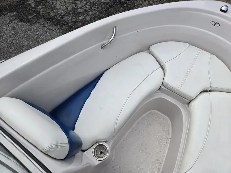 Slide: The Image of 2006 Tahoe Q6 boat interior with white and blue seating, cup holder, and handle. - 12