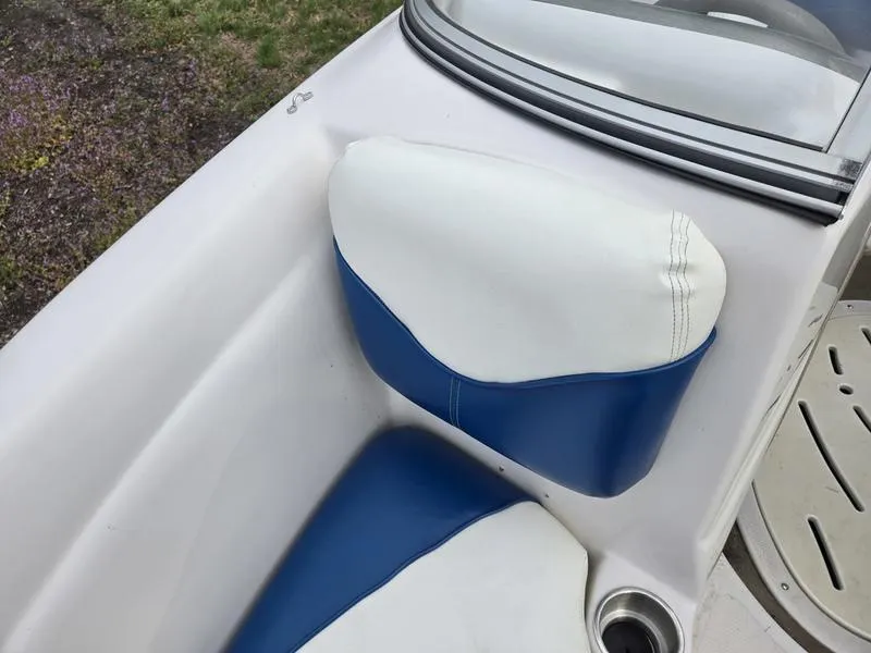 Slide: The Image of 2006 Tahoe Q6 boat interior with blue and white seating, cup holder, and windshield. - 14