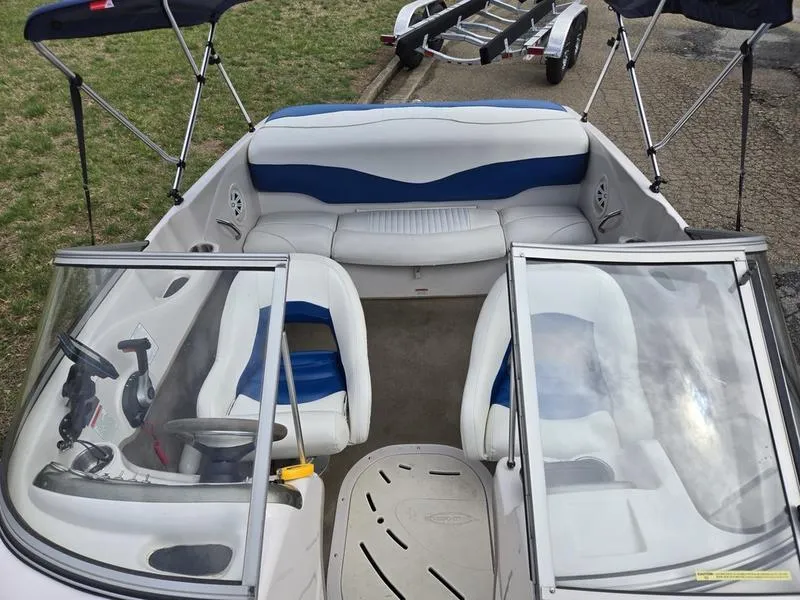 Slide: The Image of 2006 Tahoe Q6 boat interior with white and blue seating, steering wheel, and windshield. - 15
