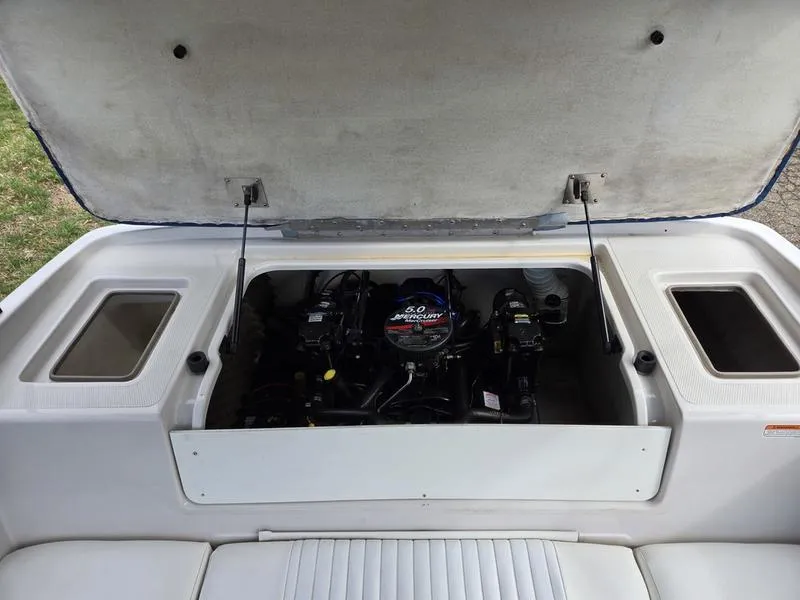 Slide: The Image of 2006 Tahoe Q6 boat engine compartment with open hatch, showcasing engine details. - 17
