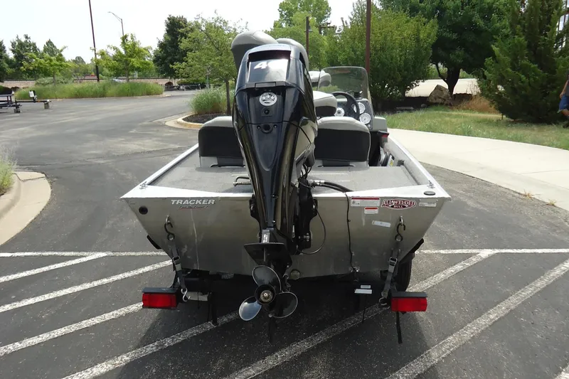 Slide: The Image of 2017 Tracker PRO160 boat rear view with outboard motor in parking lot. - 2