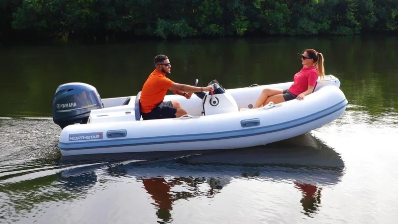 The Image of 2024 Northstar Axis 3.8 inflatable boat on a calm river. - 1