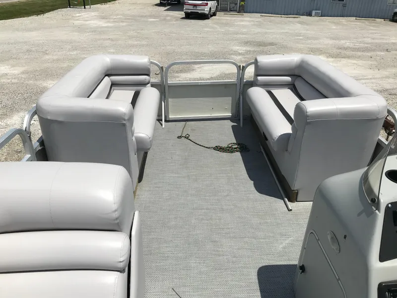 Slide: The Image of 1998 Bennington 2050LX pontoon boat interior with gray seating and open deck. - 10