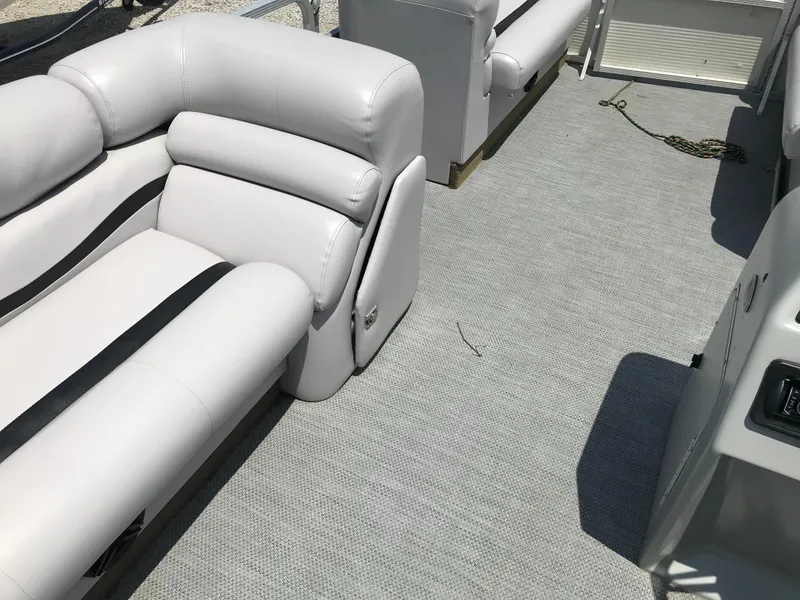 Slide: The Image of Interior of a 1998 Bennington 2050LX boat with white cushioned seating. - 12