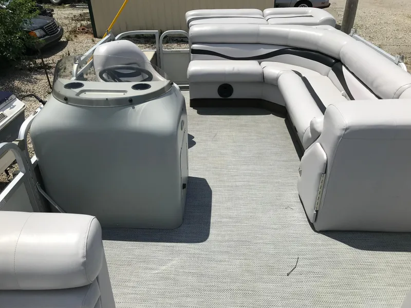 Slide: The Image of 1998 Bennington 2050LX pontoon boat interior with white seating and steering console. - 13