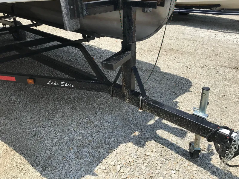 Slide: The Image of Trailer hitch of a 1998 Bennington 2050LX boat on gravel surface. - 16