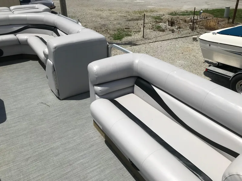 Slide: The Image of Interior of a 1998 Bennington 2050LX boat with gray cushioned seating. - 5