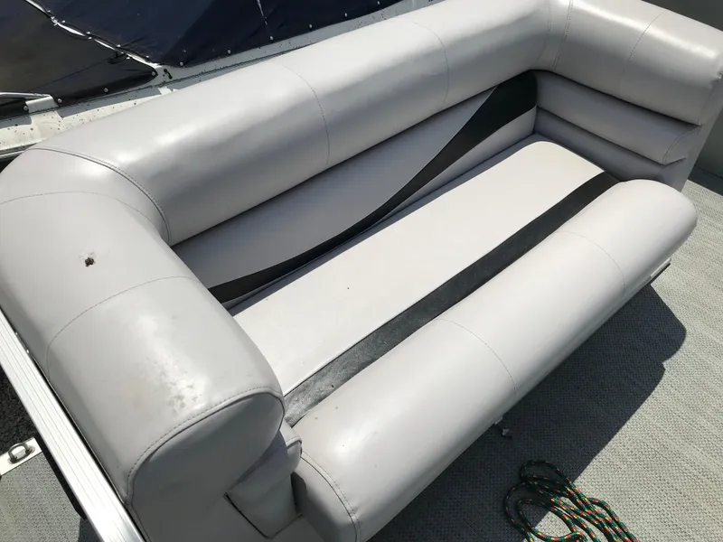 Slide: The Image of Gray seating on a 1998 Bennington 2050LX boat, with visible wear and a rope nearby. - 6