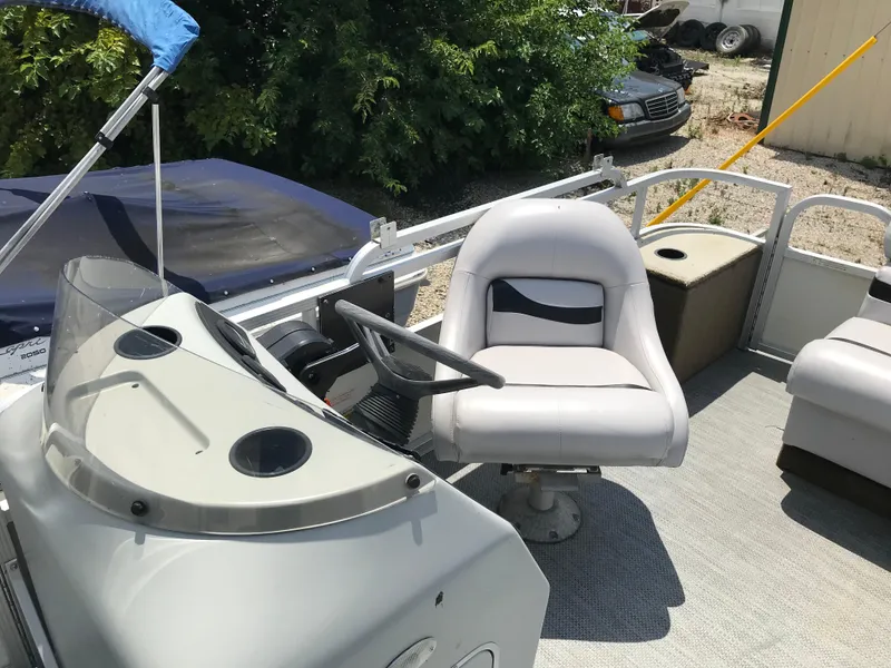 Slide: The Image of 1998 Bennington 2050LX boat interior with steering wheel and seating area. - 7